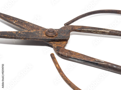 Old rusty scissors on white background
