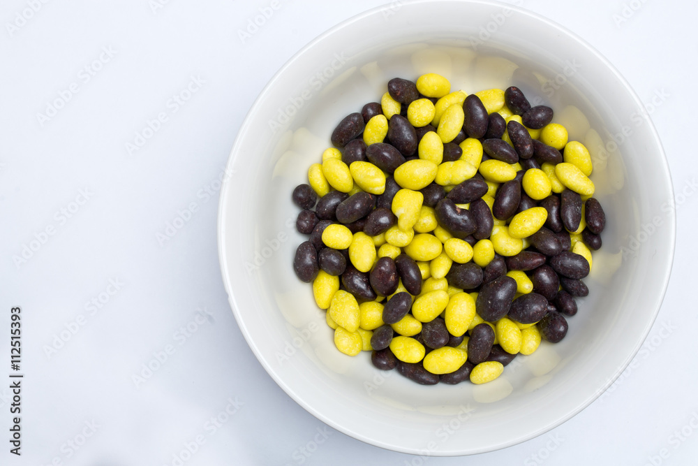 yellow and black jelly beans in the plate yellow and black jelly beans in the plate