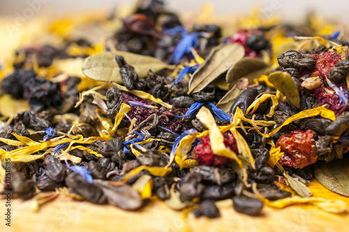 Collection of the herbal tea with berries on the wooden table - background