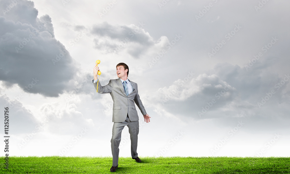 Businessman with yellow receiver Businessman with yellow receiver