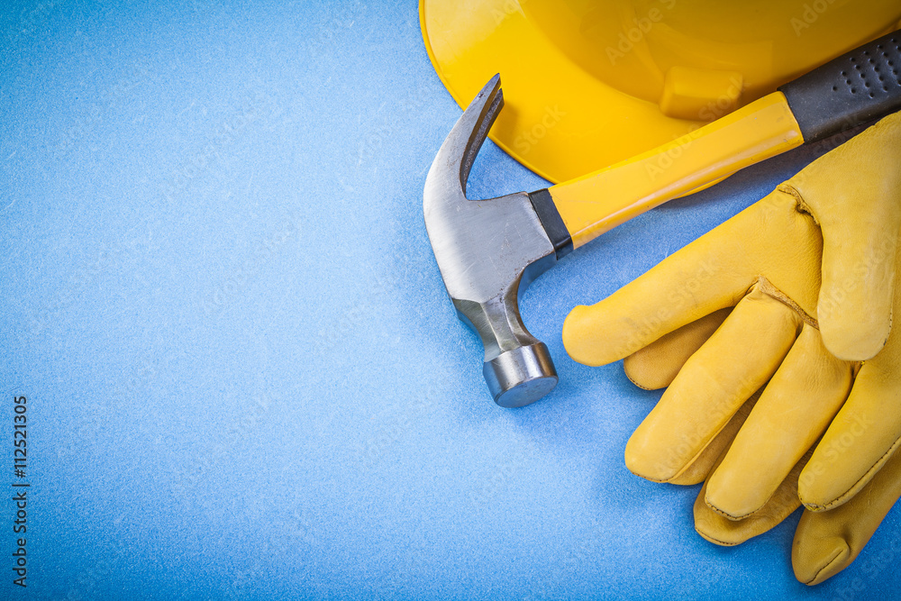 Claw hammer protective gloves hard hat on blue background horizo