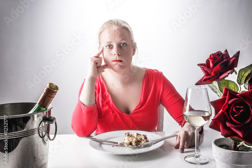 Eating too much, overeating concept, woman at dinner, diet concept photo