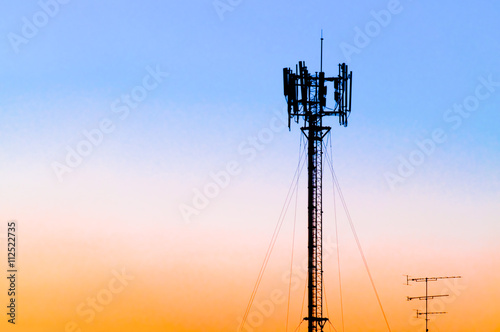 Silhouette of gsm tower against sunset sky