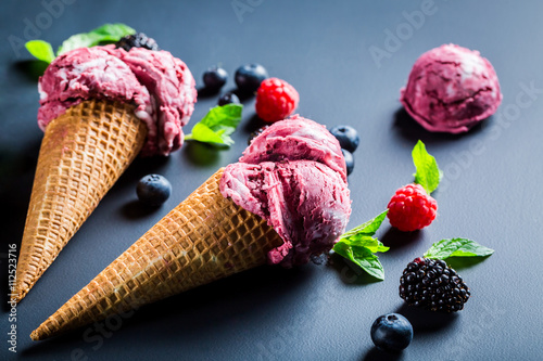 Homemade berry fruits ice cream and mint leaves