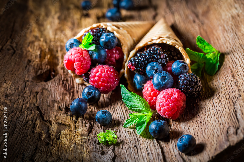 Fresh ice cream with berry fruits on wooden bark as concept