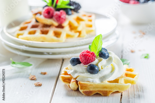 Homemade waffels with berry fruits and mint leaves