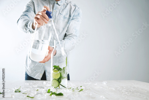 Photos Man cooks homemade lemonade, pours sparkling water from soda syphon to vintage b