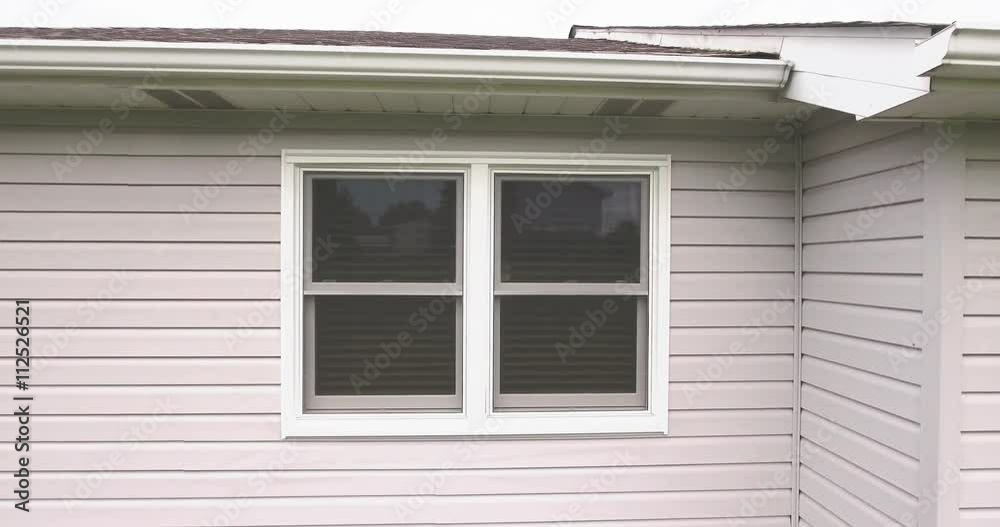 A drone drops outside a window and tries to spy into a home as the owner shuts the blinds. A drone drops outside a window and tries to spy into a home as the owner shuts the blinds.