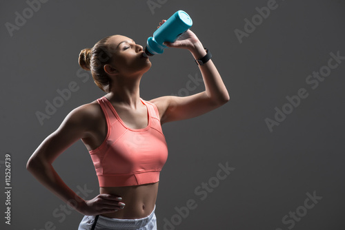 Attractive young woman enjoying drink after exercising © Yakobchuk Olena