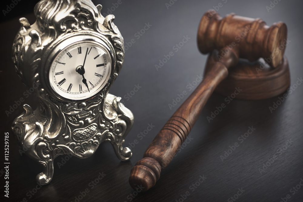 Judges Hammer or Gavel With Old Clock On Dark Background Judges Hammer or Gavel With Old Clock On Dark Background