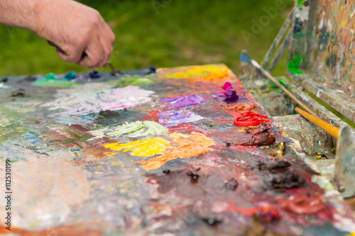 Big painter's palette with fresh paint outdoors