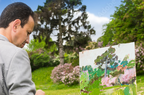 Portrait of an artist working outdoors in the park or garden