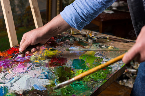 Male artist's hand working with palette