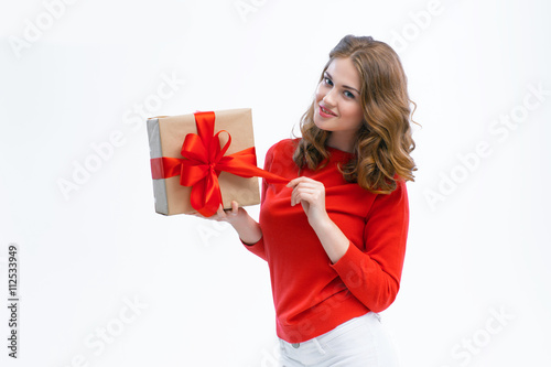 Joyful woman holding a box with gift © pinkfishstock