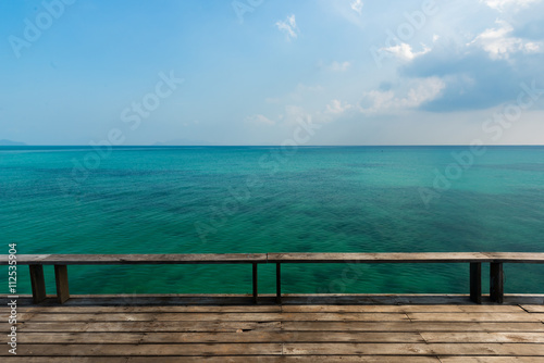 Wooden platform beside tropical sea, Old wooden bridge or wooden deck at blue sea , Wooden deck for relaxation at Koh Kood Island, Thailand
