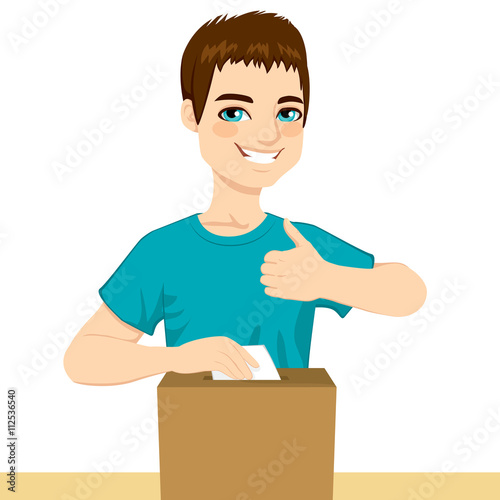 Young happy man voting on political decision inserting ballot on poll box and with thumb up on elections day