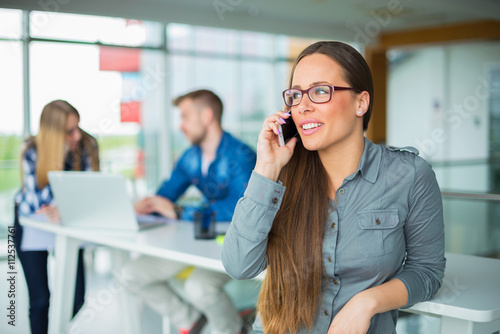 She's always available. Happy businesswoman in office