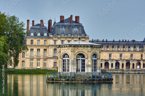 Park, pond and the palace of Fontainebleau in France.