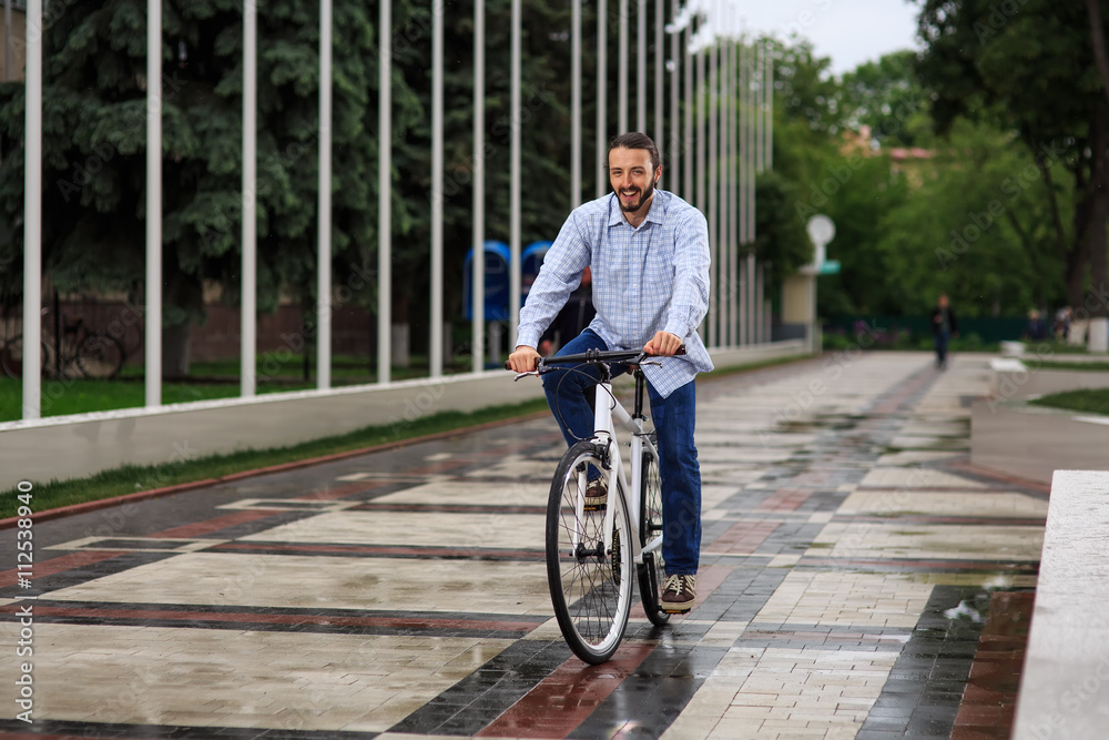 Fototapeta premium young hipster man with fixed gear bike on city street