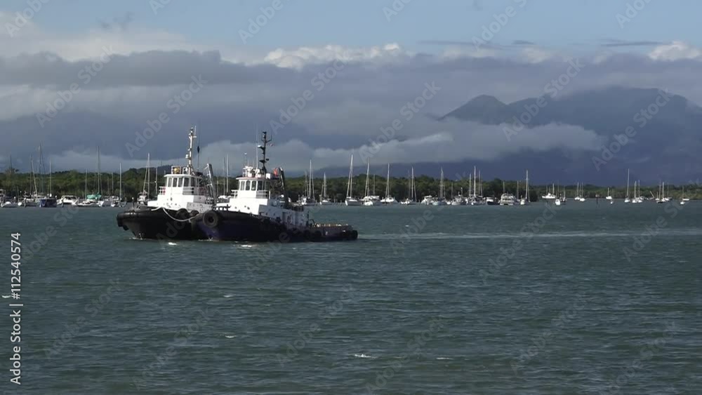 Two tugboats sail in Trinity Inlet Cairns Queensland Australia Two tugboats sail in Trinity Inlet Cairns Queensland Australia