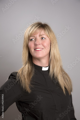 Portrait of a female clergy wearing a black shirt and dog collar