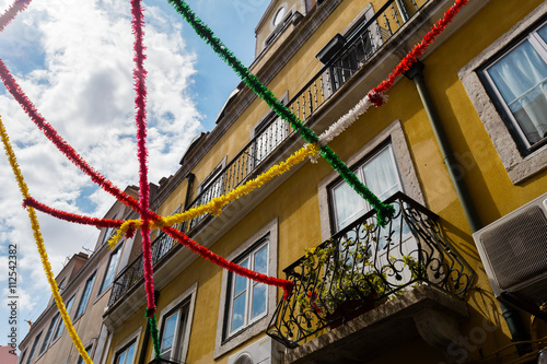 Feast on the street in Porto, Portugal. In celebration streets decorated with colorful ribbons