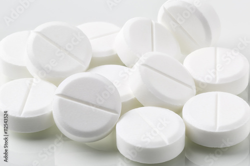Heap of white round pills and drugs