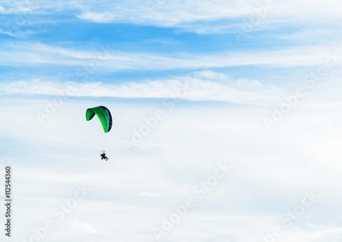 Fototapeta Naklejka Na Ścianę i Meble -  man ride Paramotor flying in the sky