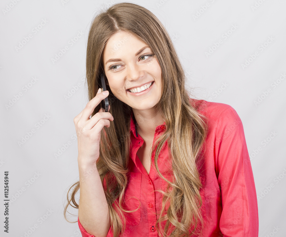 Attractive girl talking on cell in studio Attractive girl talking on cell in studio
