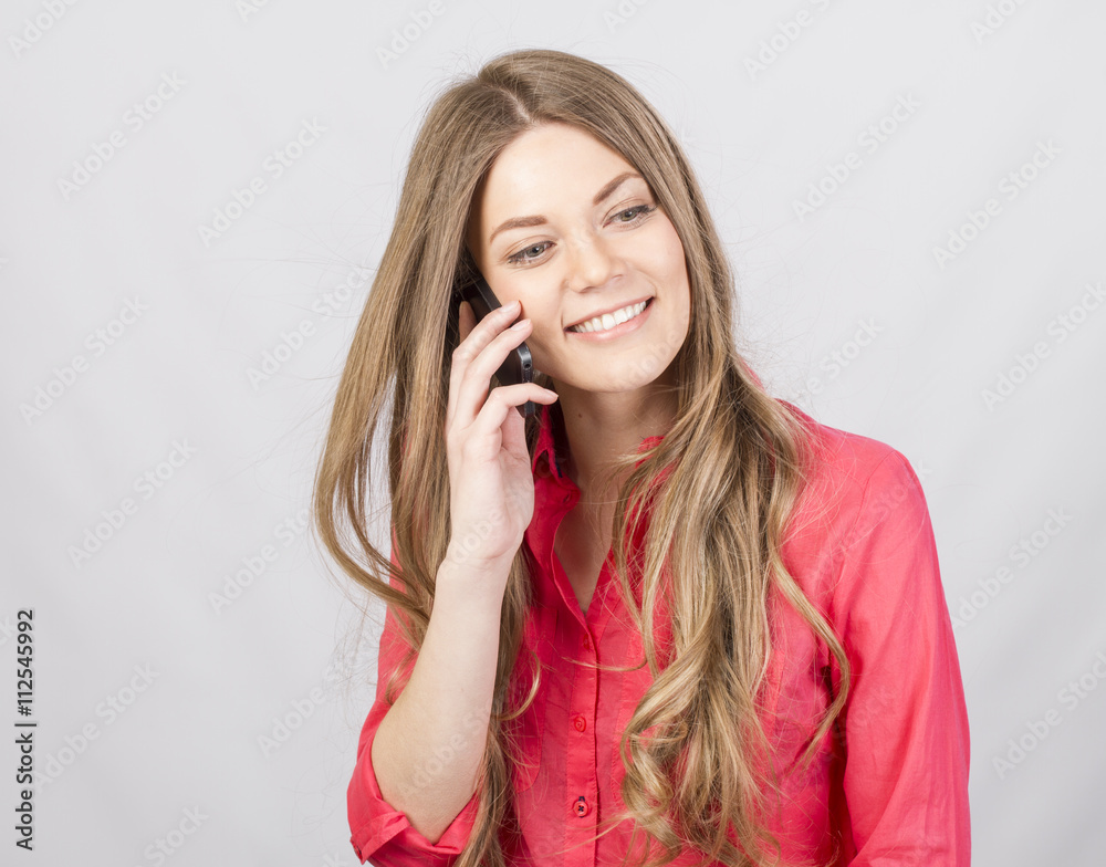 Attractive girl talking on cell in studio