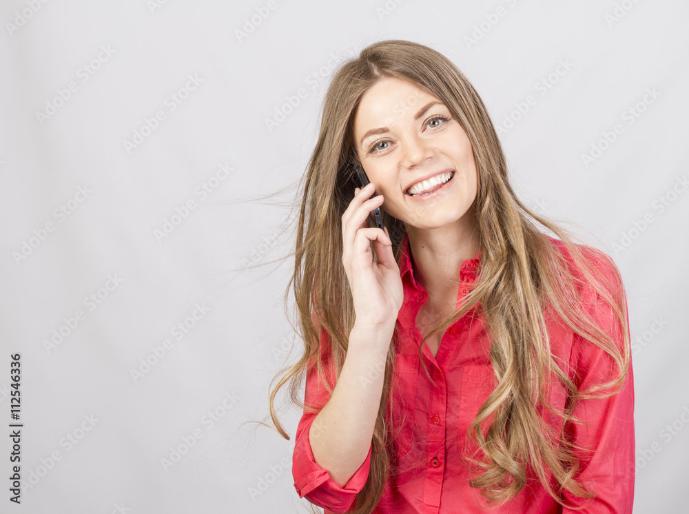 Attractive girl talking on cell in studio Attractive girl talking on cell in studio