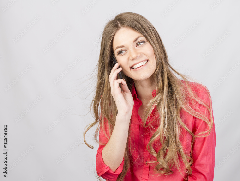 Attractive girl talking on cell in studio Attractive girl talking on cell in studio
