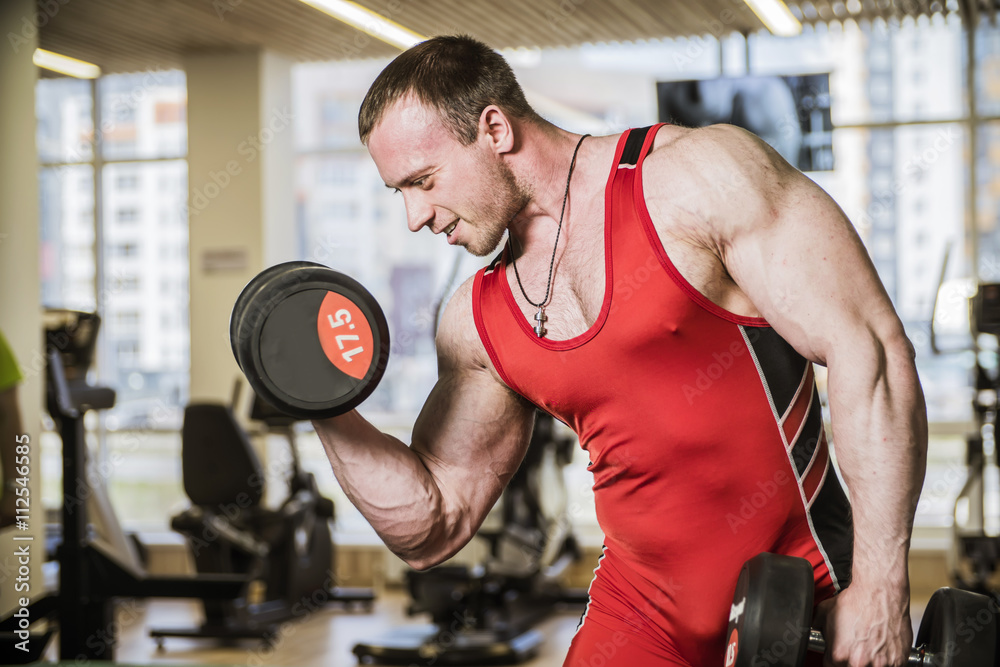 man is engaged in fitness bodybuilder dumbbell raises man is engaged in fitness bodybuilder dumbbell raises