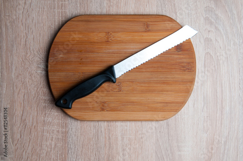 Wooden breadboard with knife