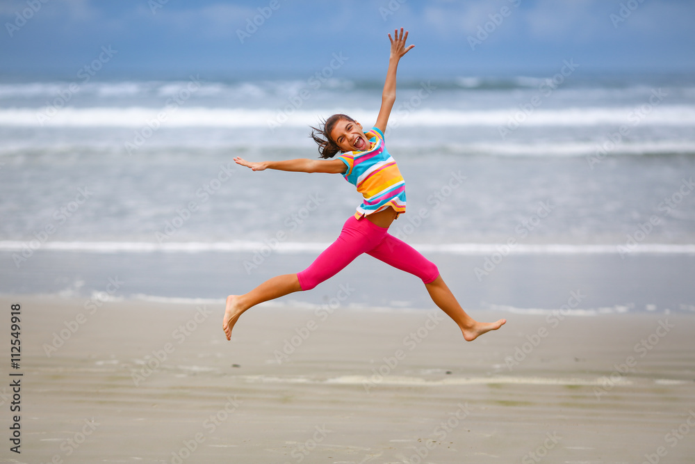 Girl jumping on the beach