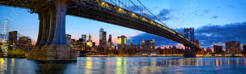 Manhattan Bridge panorama with skyline and Brooklyn Bridge at dusk  New York