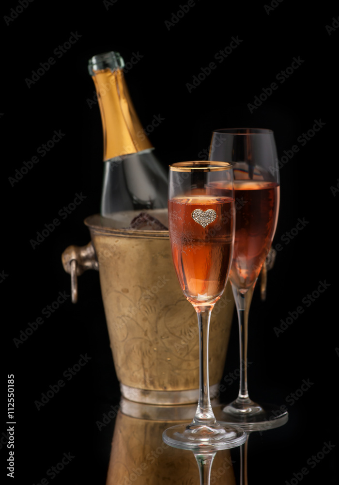 Pink Champagne in a bucket and two glasses of champagne, vertical Pink Champagne in a bucket and two glasses of champagne, vertical