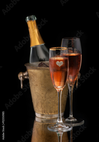 Pink Champagne in a bucket and two glasses of champagne  vertical