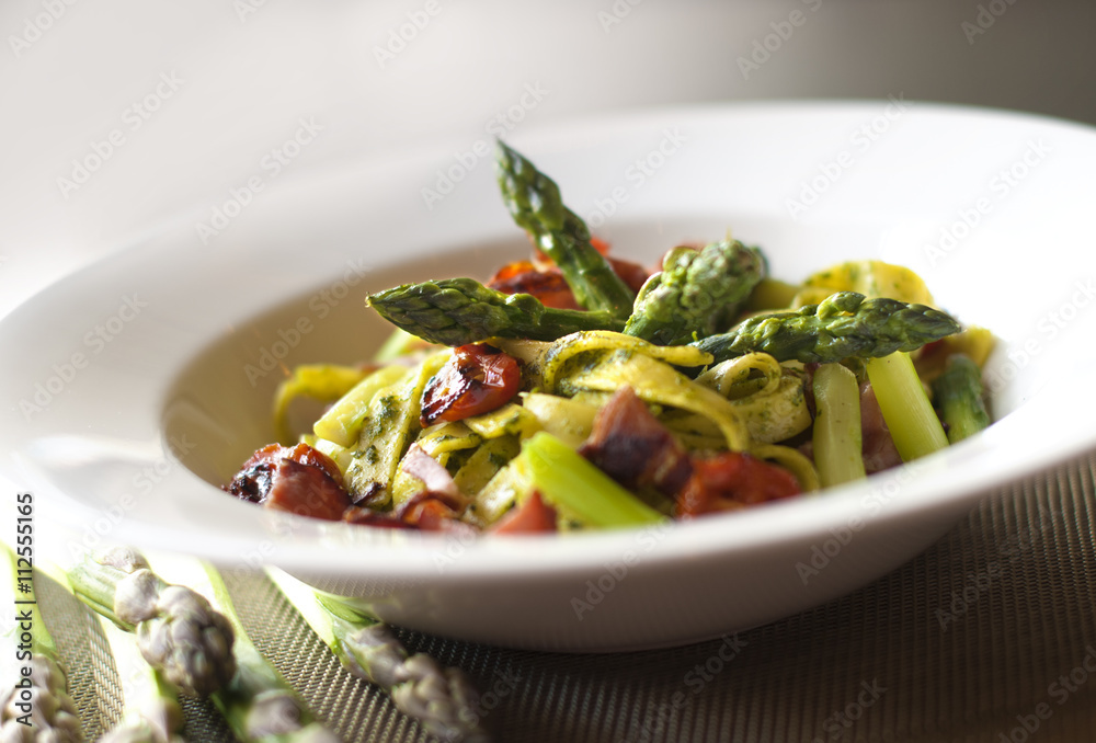 Asparagus salad with pasta, pesto, grilled cherry tomatoes and ham Asparagus salad with pasta, pesto, grilled cherry tomatoes and ham