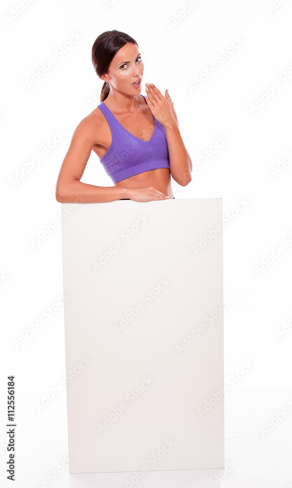 Healthy surprised brunette holding blank placard Healthy surprised brunette holding blank placard