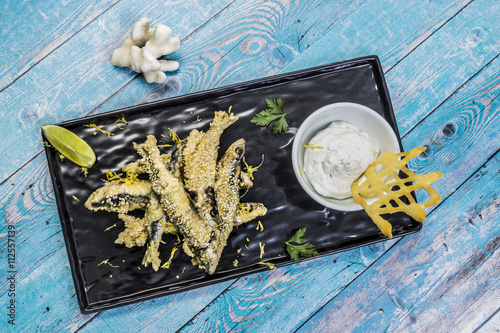  fried sardines with sesame and sauce photo