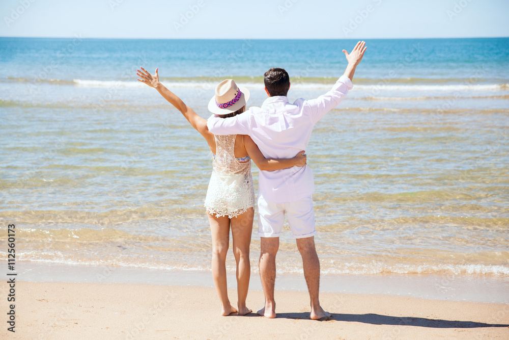 Couple at the beach for their honeymoon Couple at the beach for their honeymoon