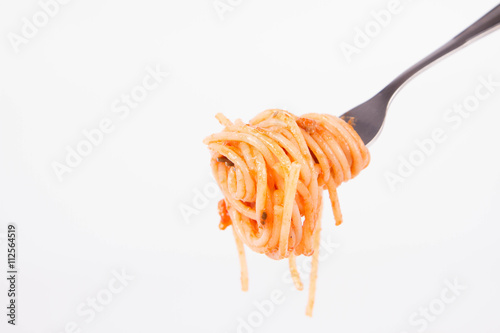Spaghetti covered with sauce on a fork