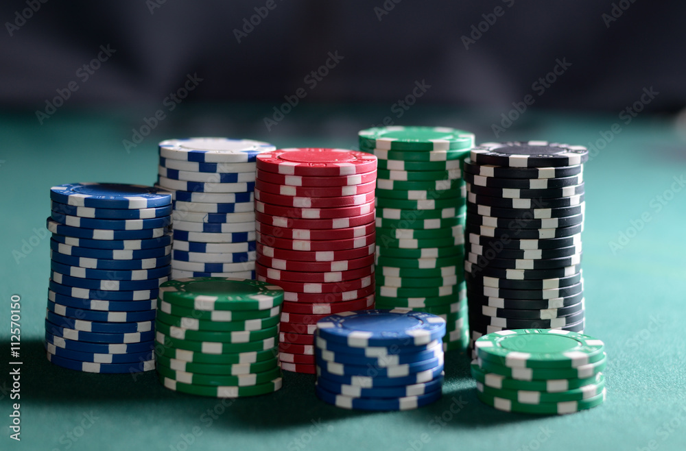 Stack of poker chips on a green table