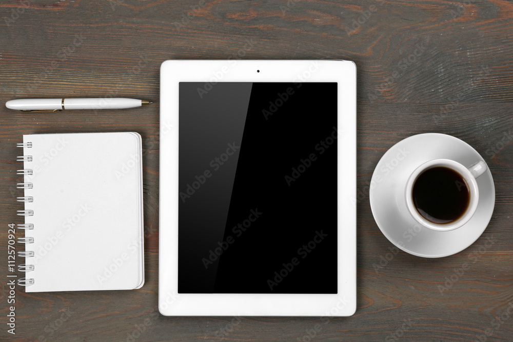 Digital tablet with cup of coffee and notebook on wooden table, closeup Digital tablet with cup of coffee and notebook on wooden table, closeup