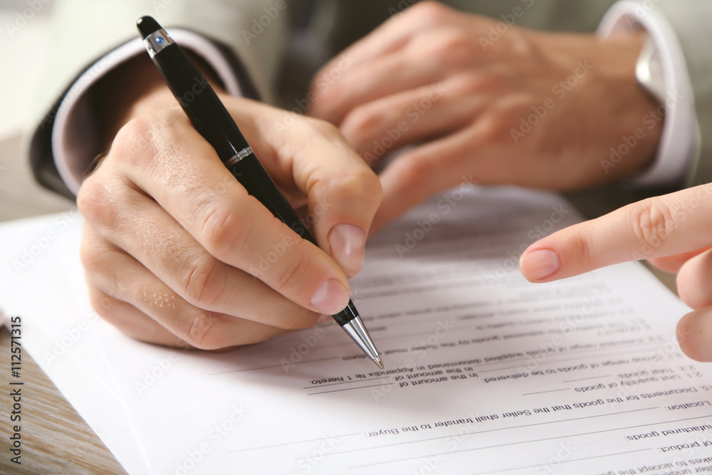 Human hands working with documents at the desk closeup Human hands working with documents at the desk closeup