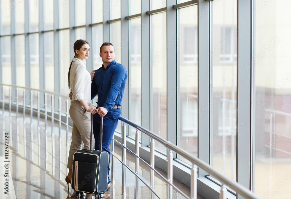 Couple in love on vacation. Couple standing in the airport. Couple in love on vacation. Couple standing in the airport.