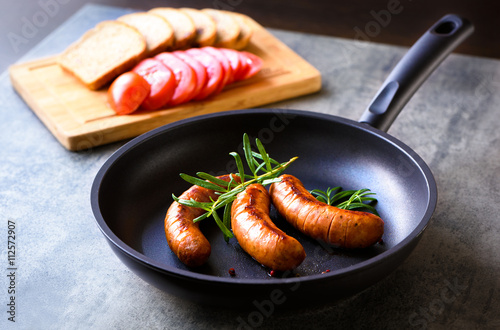 Sausages frying in a skillet  photo