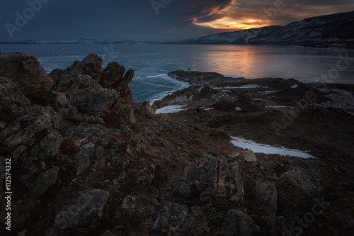 Rocks above frozen Baikal lake at the sunrise