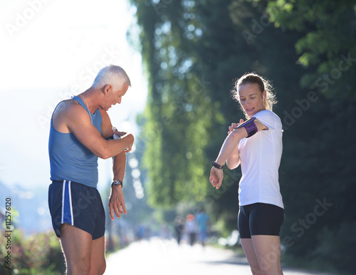 jogging couple planning running route and setting music